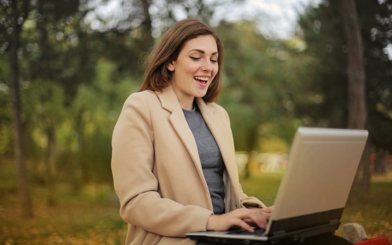Woman using a laptop computer outside